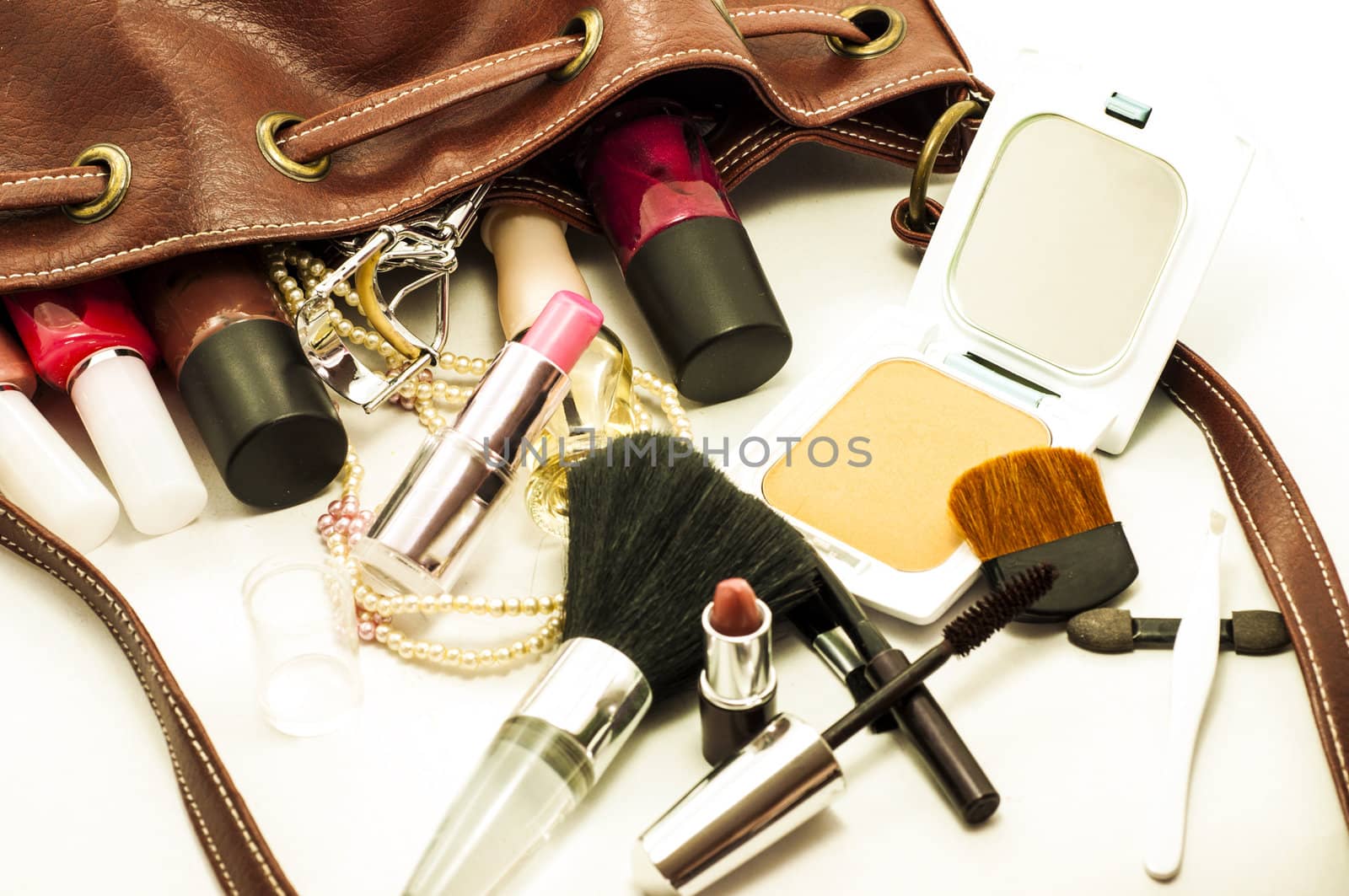 woman leather bag with cosmetics , tools and brushes by TanawatPontchour