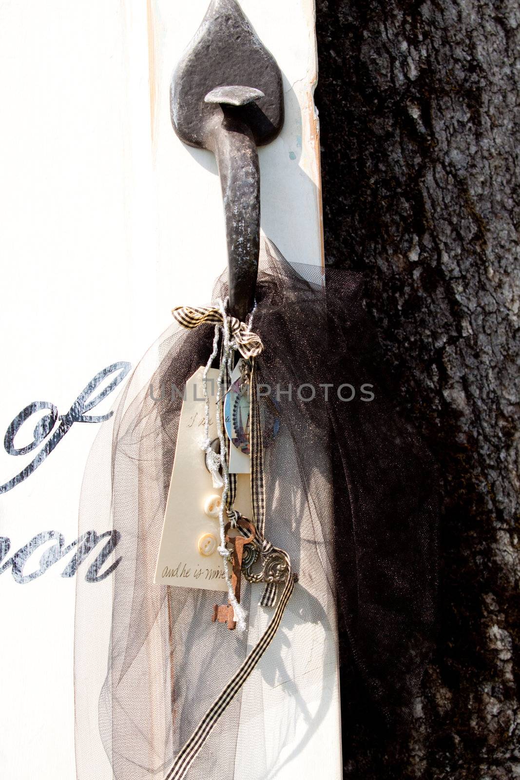 Items hang from a door handle at a wedding ceremony.