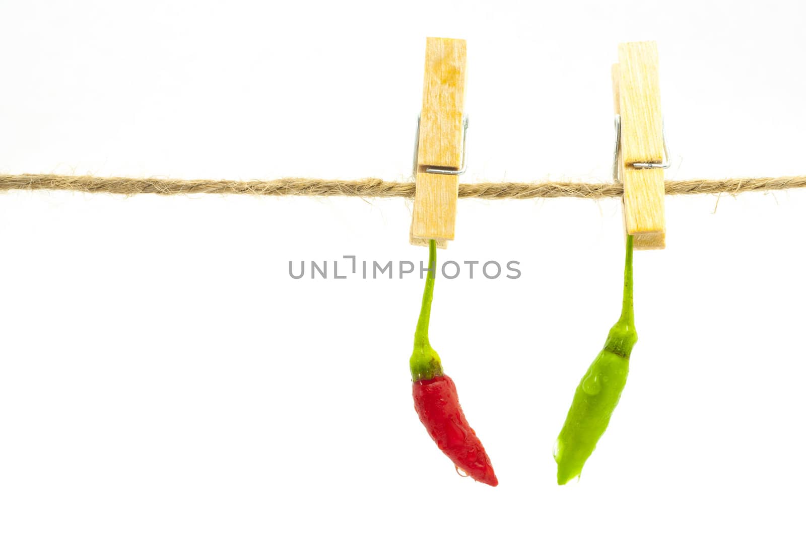 Red and green chilli hanging on clothespin