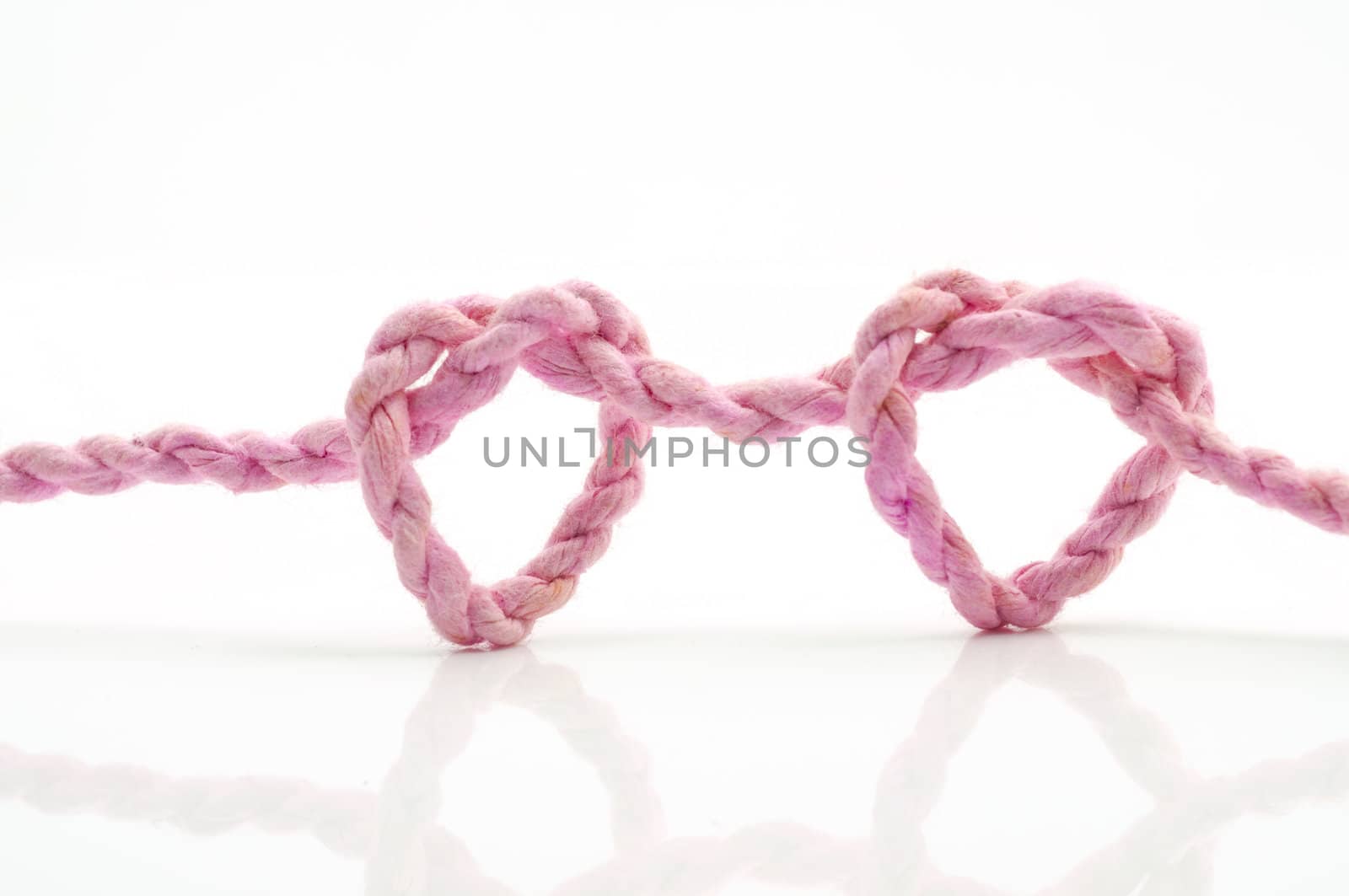 pink rope heart shaped symbol by TanawatPontchour