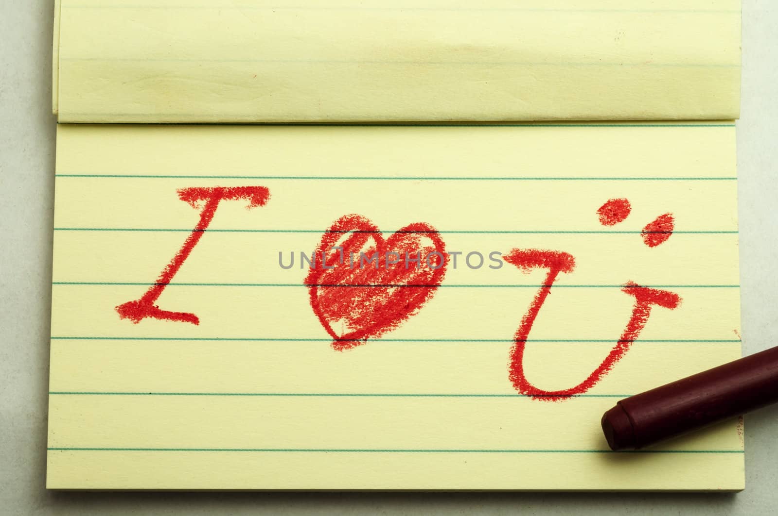 Hand writing love note with crayon