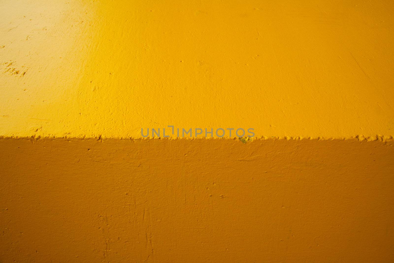 Abstract shot of the edge of a building turned horizontally to create a background image of two shades of color.