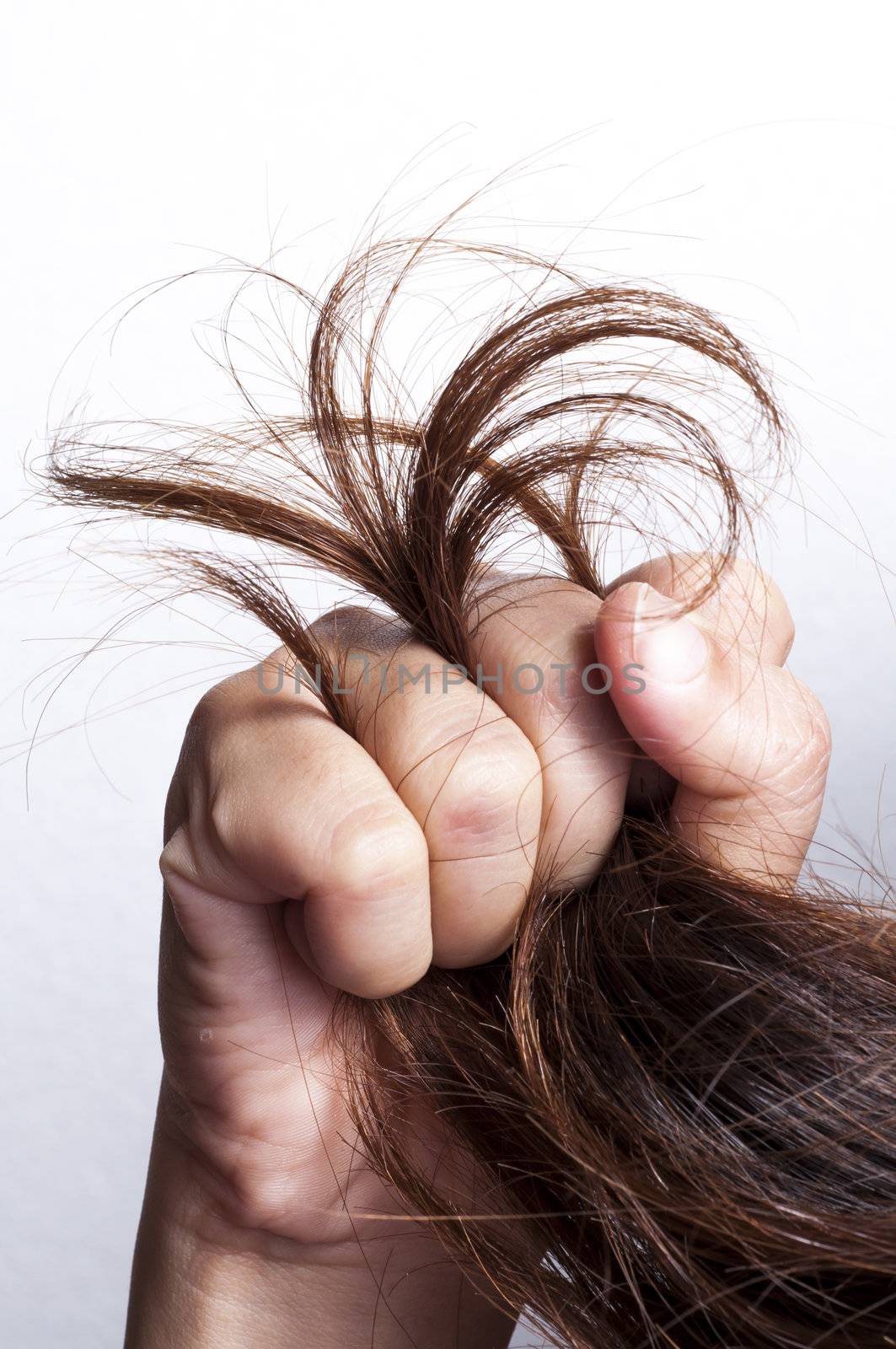 Woman hand grabbed damaged hair