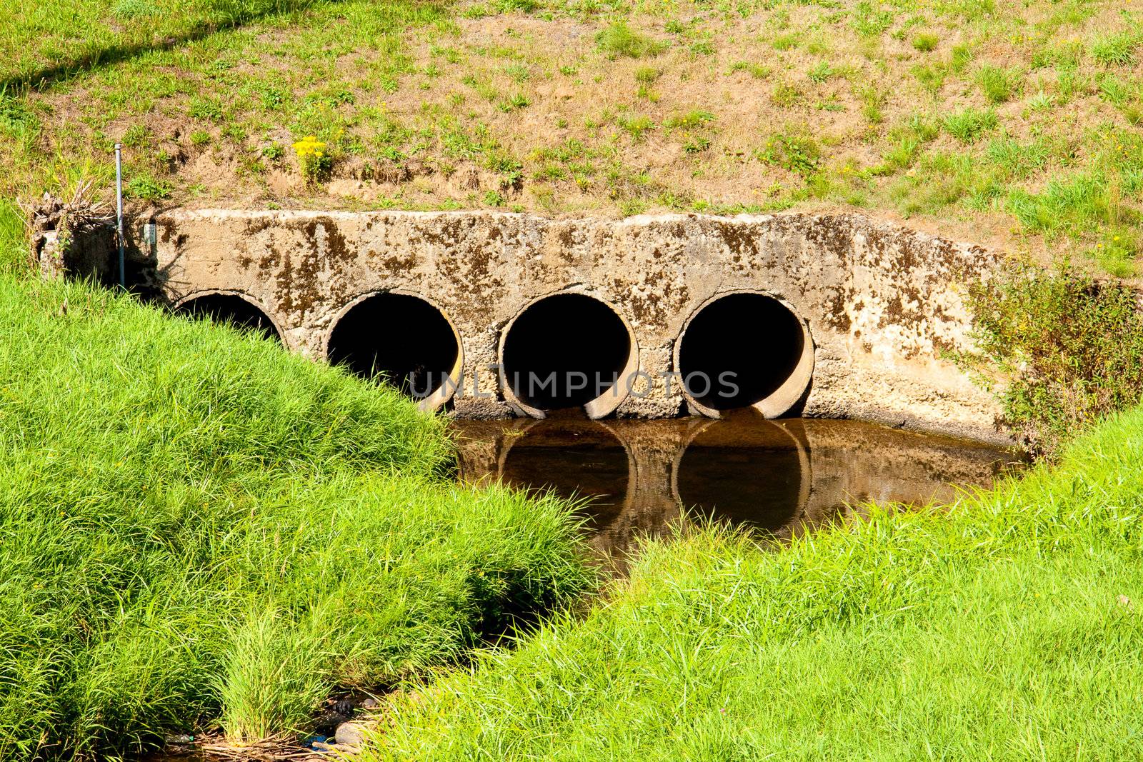 Four tunnels create a passageway for water under a road.