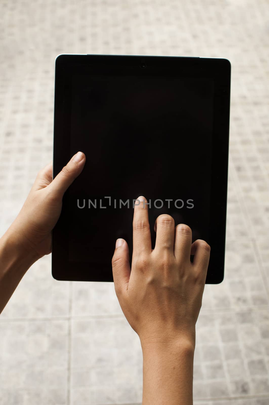 Woman hand with touch screen device by TanawatPontchour