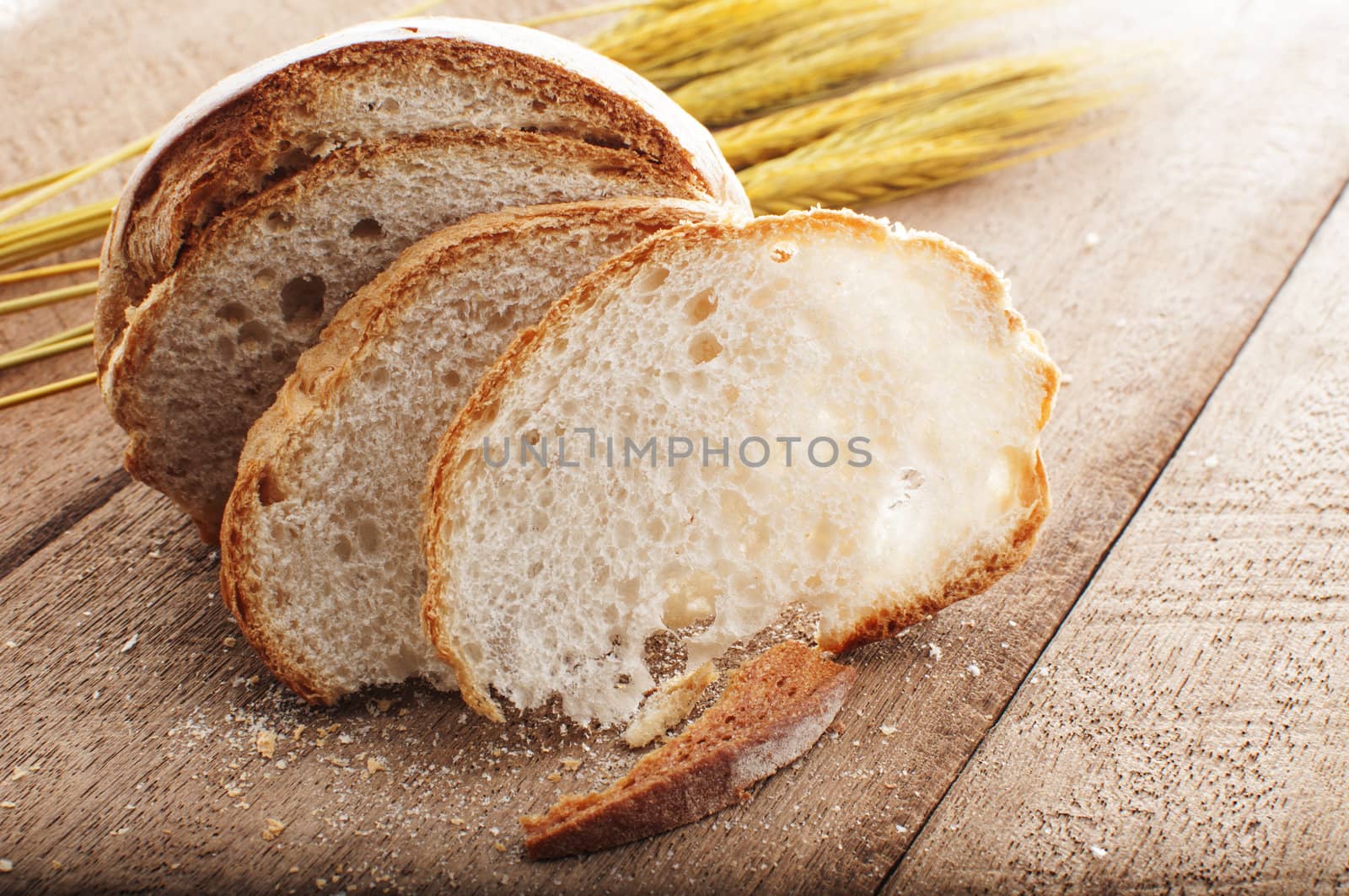 sliced bread and wheat on the wooden table