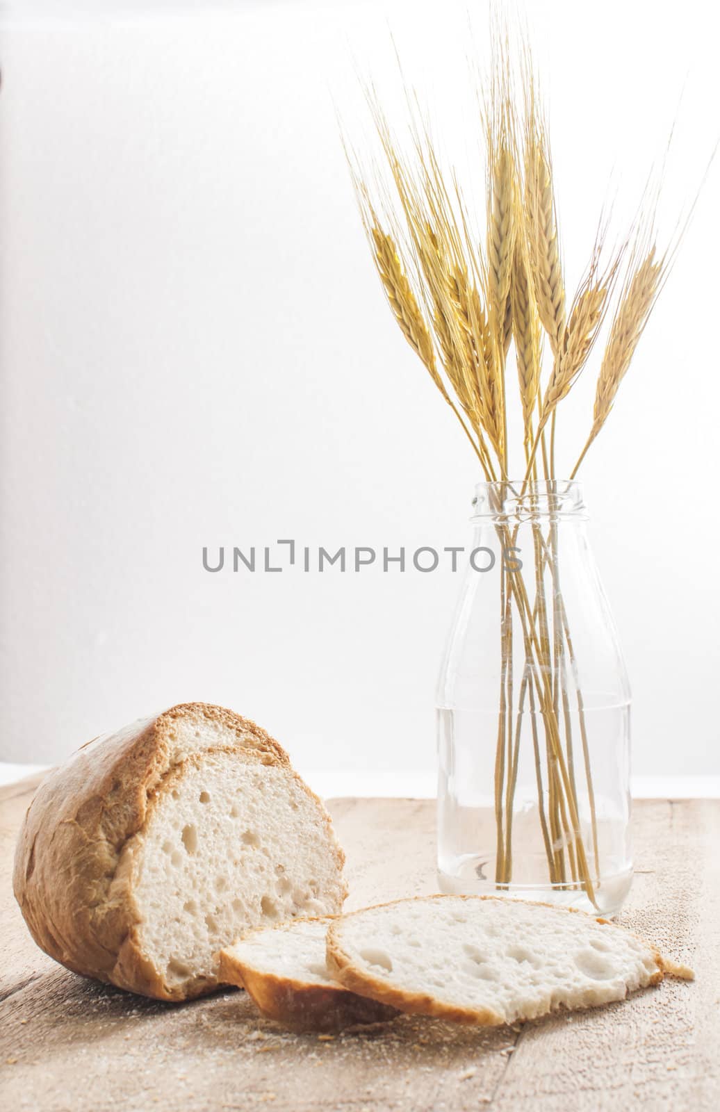 sliced bread and wheat on the wooden table