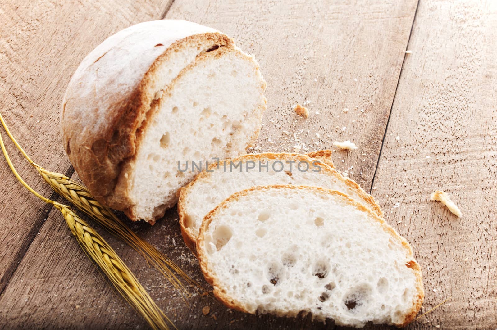 sliced bread and wheat on the wooden table