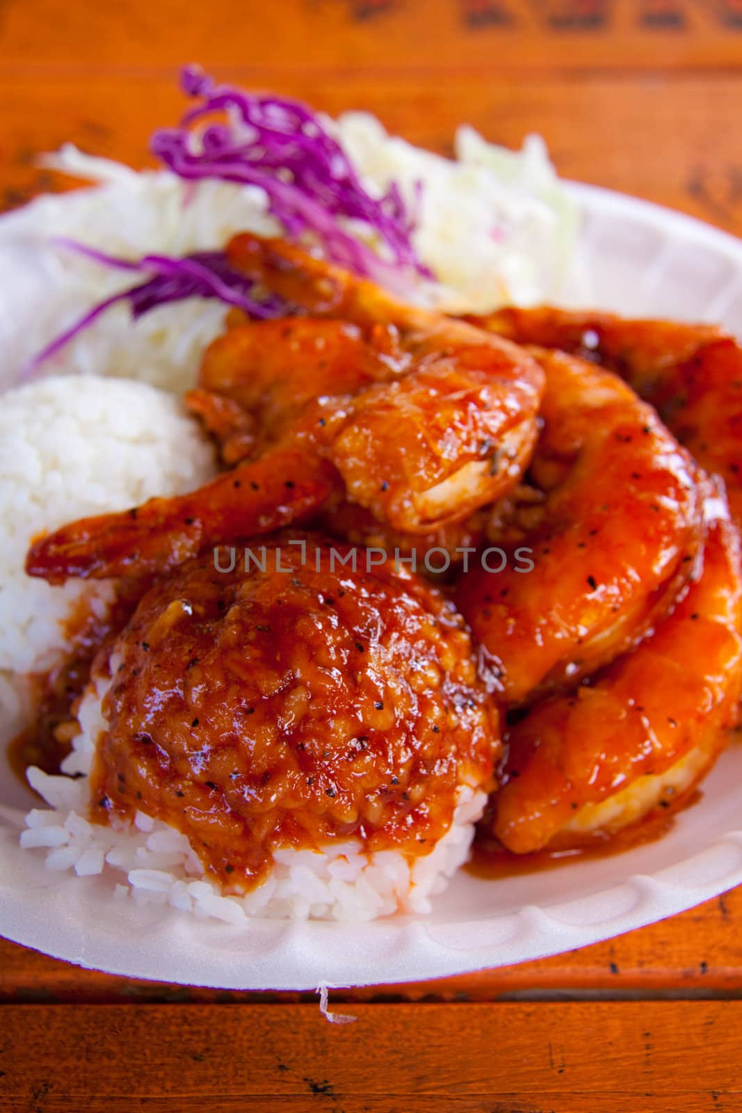 A nice plate of shrimp, rice and pineapple or garlic with rice and coleslaw in Hawaii.