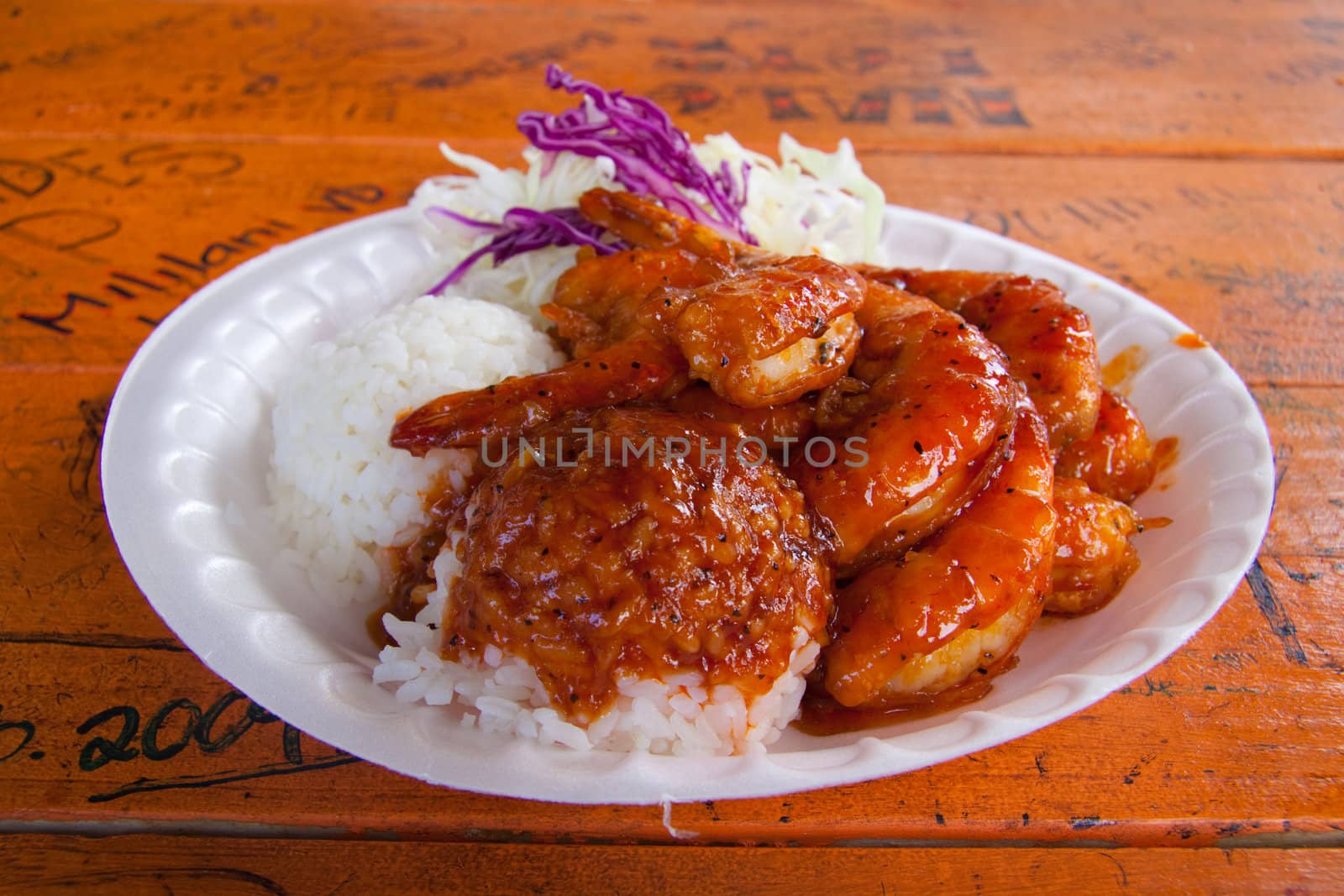 A nice plate of shrimp, rice and pineapple or garlic with rice and coleslaw in Hawaii.