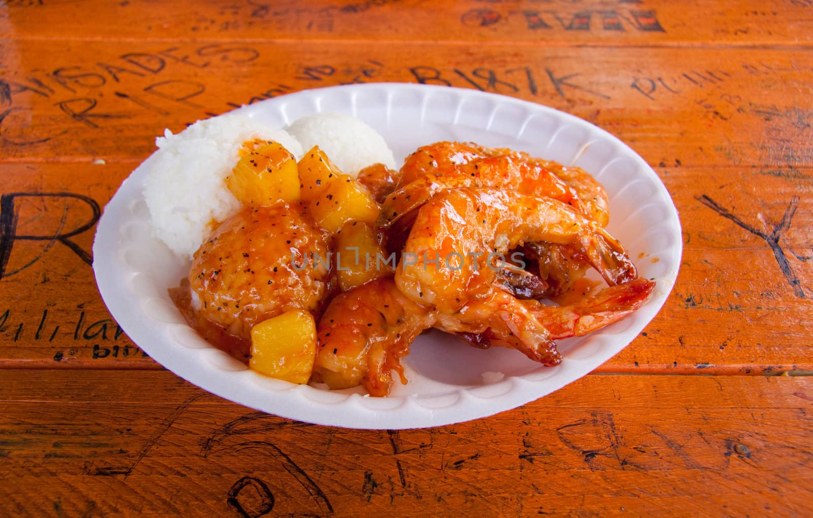 A nice plate of shrimp, rice and pineapple or garlic with rice and coleslaw in Hawaii.