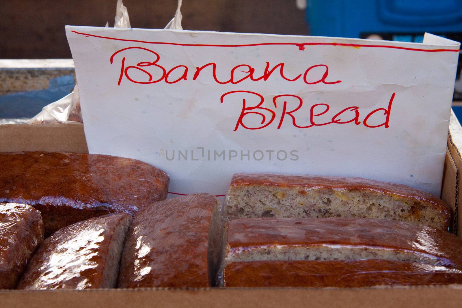 A farmer's market is selling hawaiian banana bread made from organic bananas on the north shore of oahu hawaii.