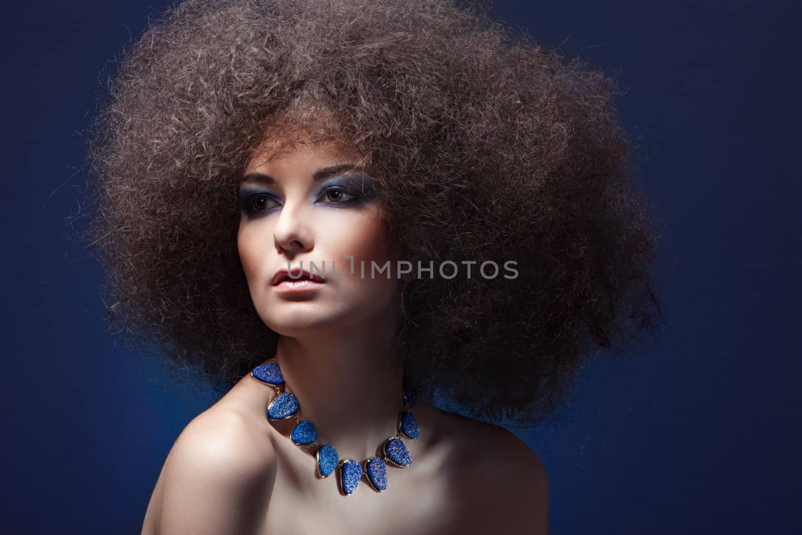 beauty woman with curly hair with blue make-up