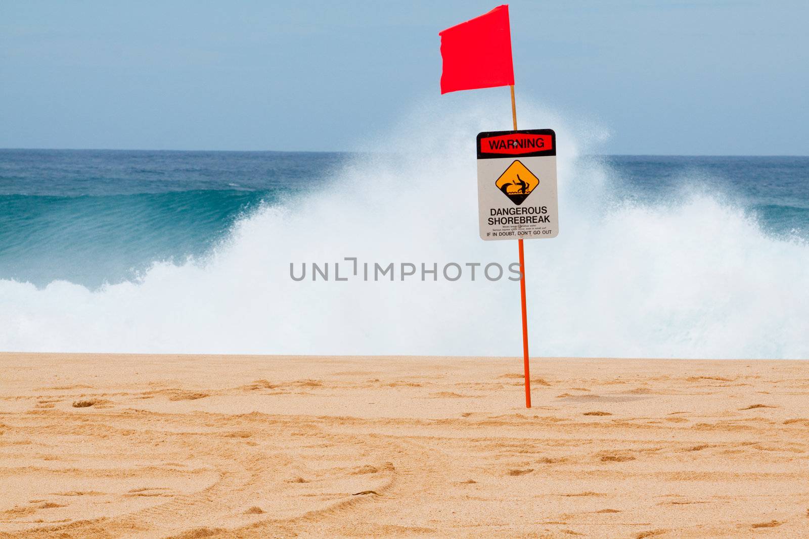 Warning signs mark where there is a very dangerous shore break and rip current along the north shore of Oahu Hawaii.