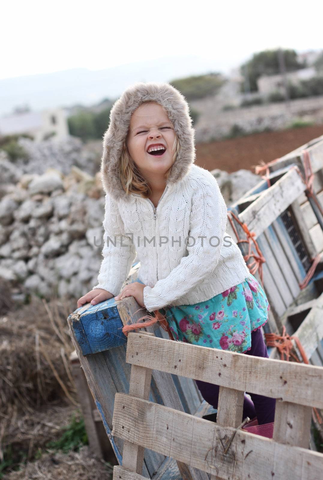 Little girl with a hood doing a silly face