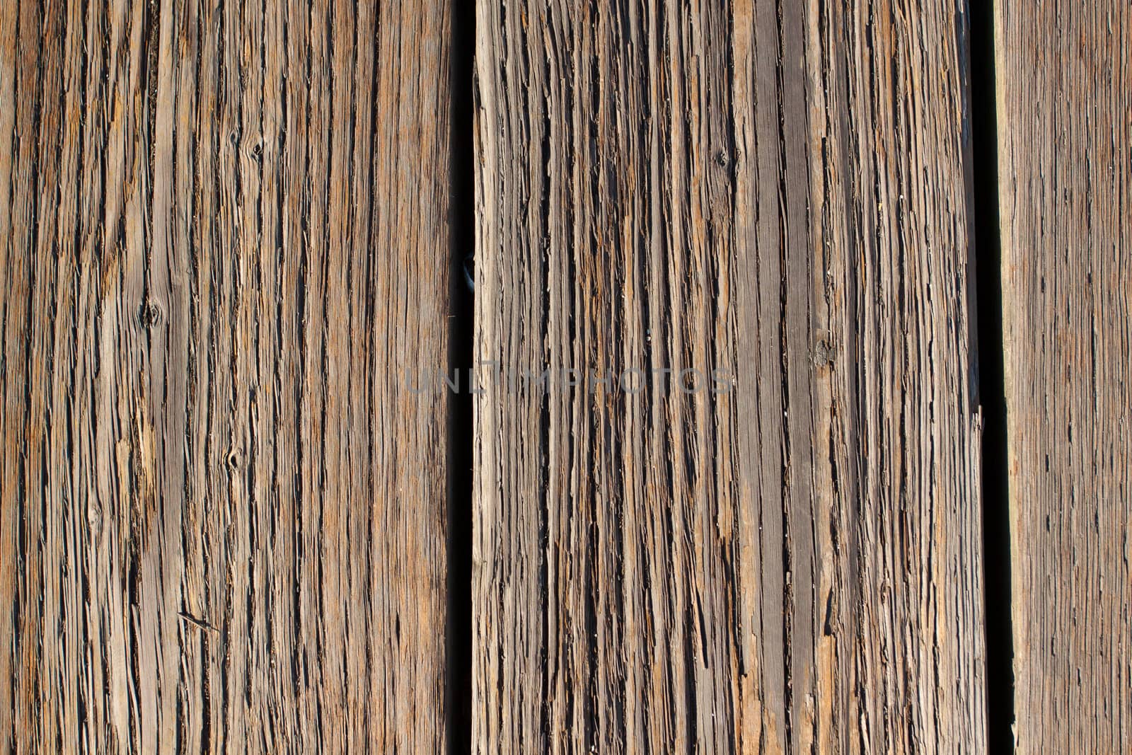 Wood boards are photographed at a dock to create some individual abstract images of the texture of wood after being weathered for many years.