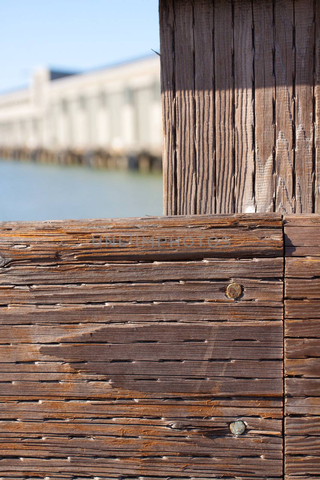 The railing of a pier is photographed in an abstract way to create some interesting texture images of wood and water.