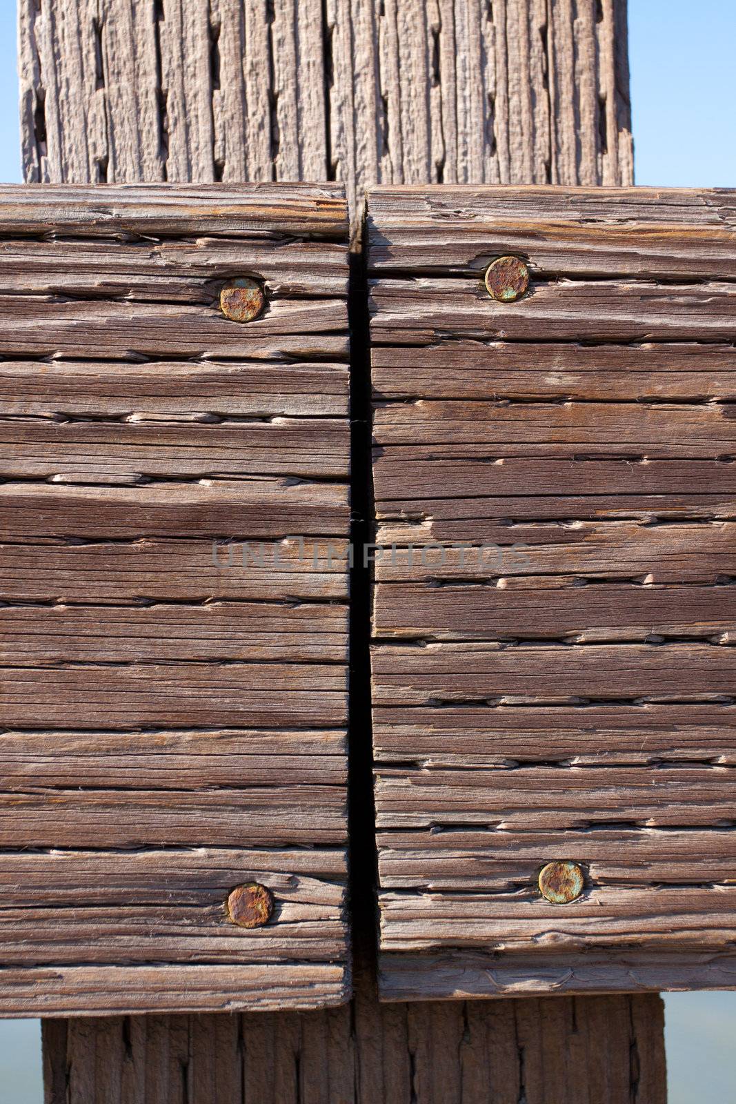 The railing of a pier is photographed in an abstract way to create some interesting texture images of wood and water.