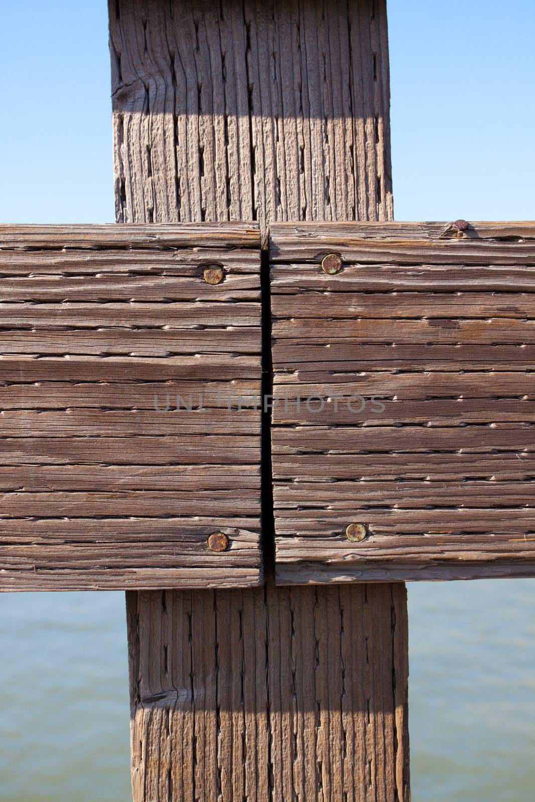 The railing of a pier is photographed in an abstract way to create some interesting texture images of wood and water.