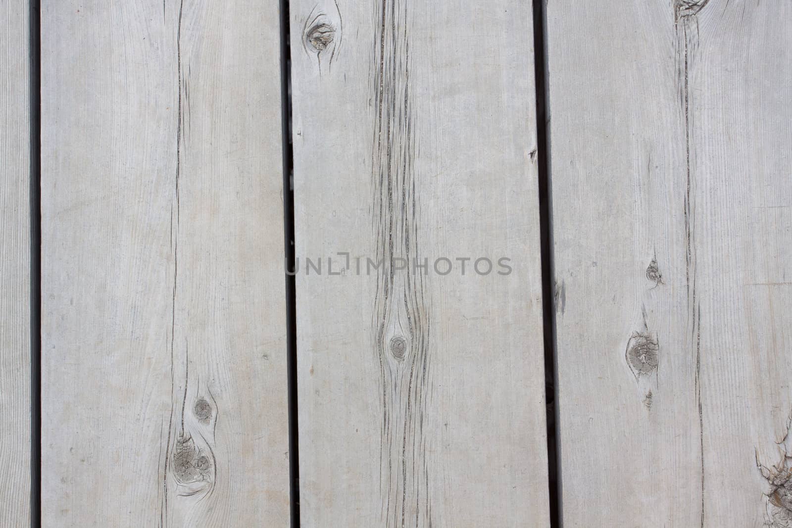 A very old section of a dock at Lake Tahoe showing the wooden planks and boards that make up the structure.