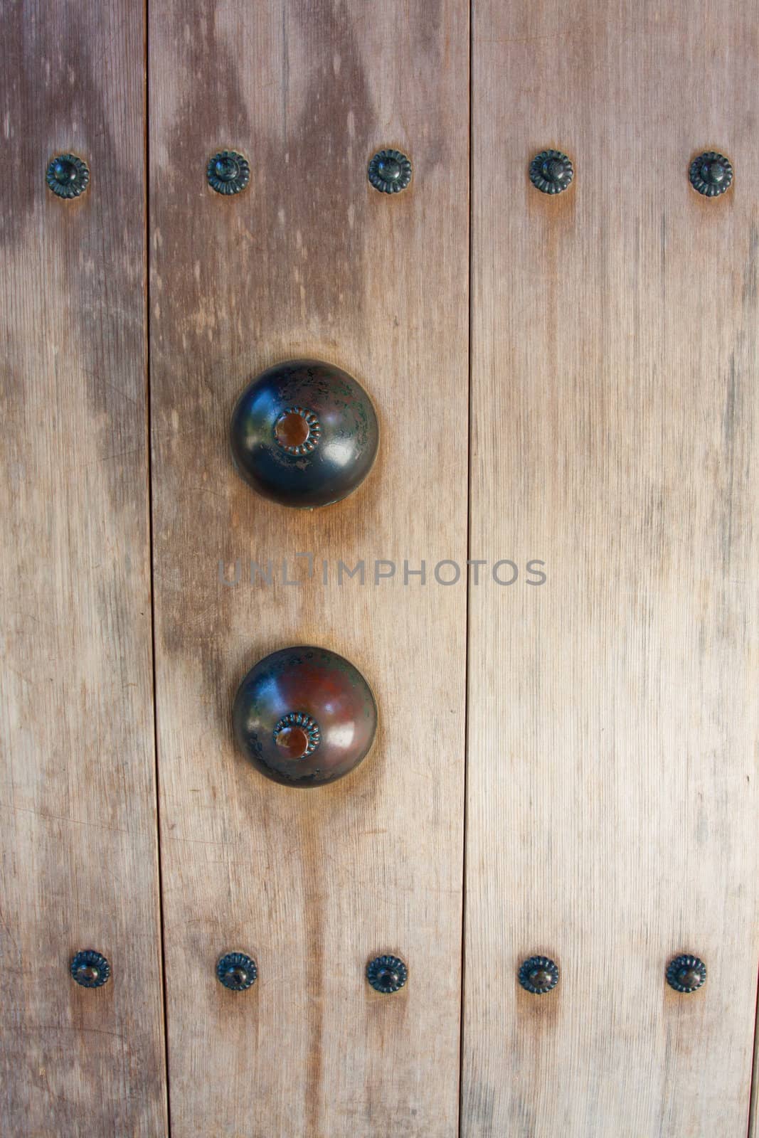 Metal pieces mounted to wood are photographed in a way to make an abstract texture background image from the materials.