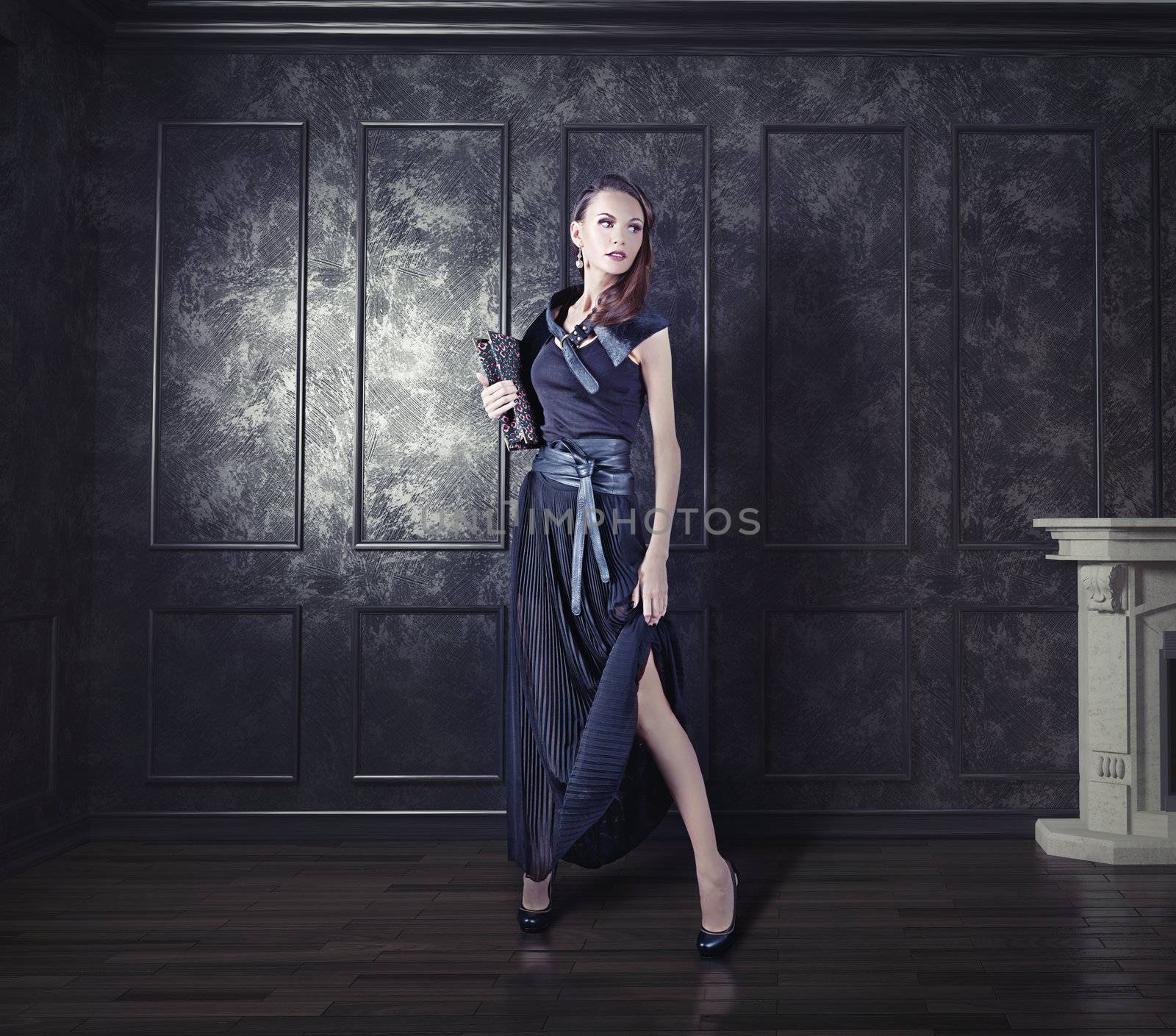 young  beautiful woman posing in an vintage room 