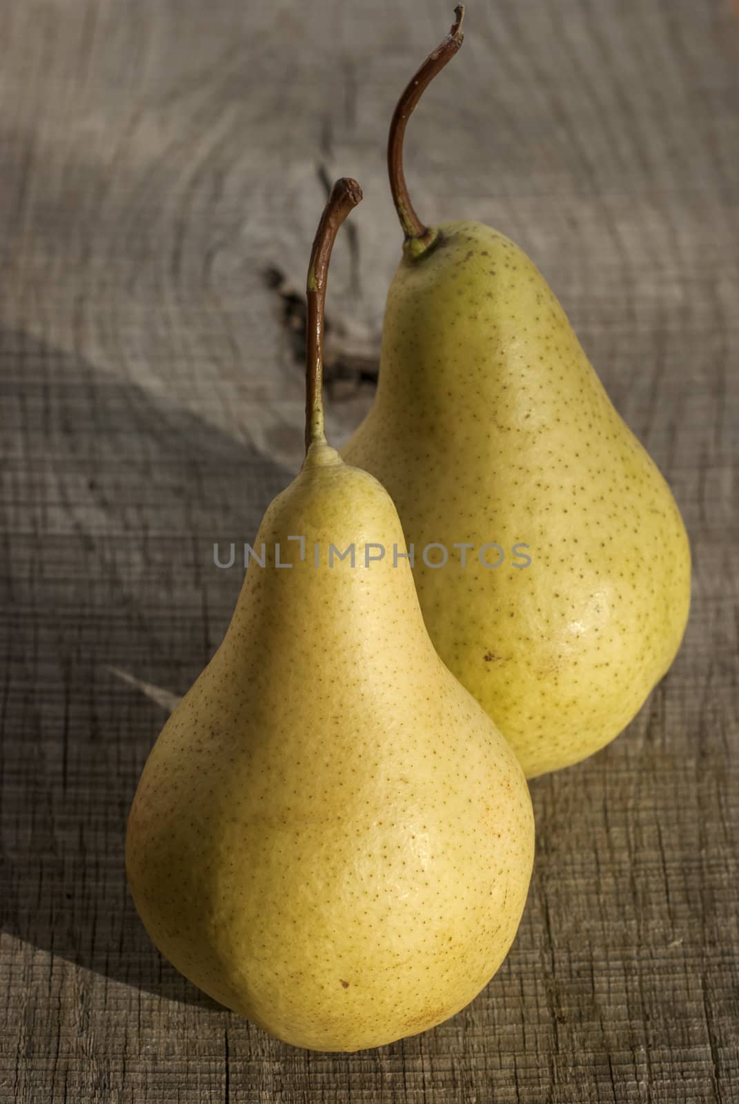 Fresh organic pears closeup on wooden board background