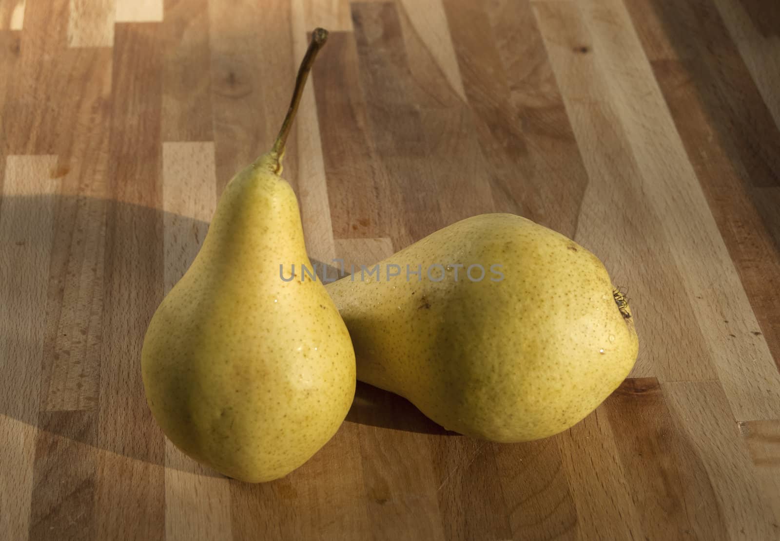 Fresh organic pears closeup on wooden board background