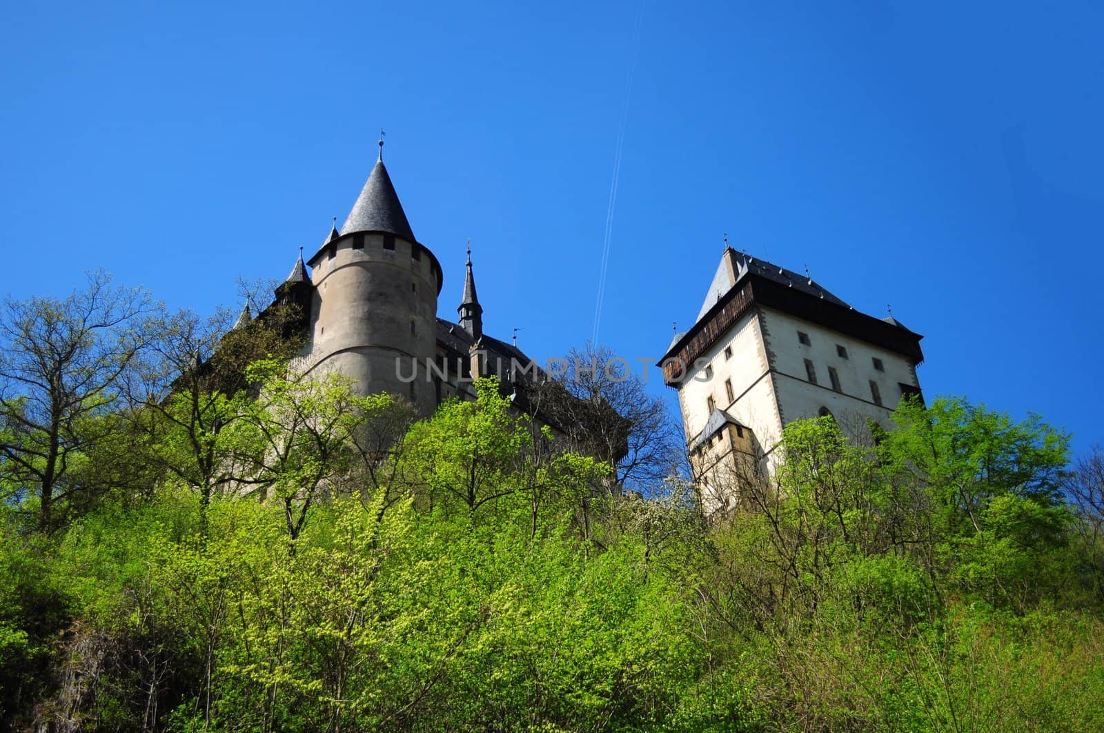 Panorama of the Karlstejn Castle over blue sky during the summer day