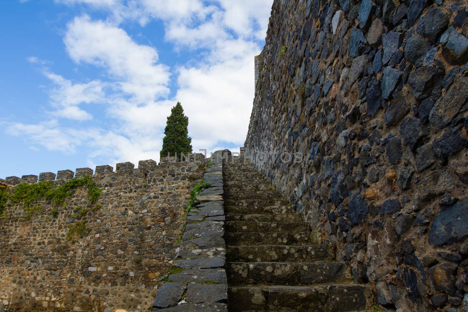 Old stone stairs, medieval wall, castle, sky by 1shostak