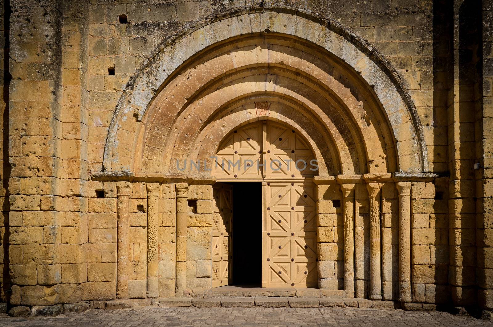 Stone church entrance door and arcs, St Emilion, France