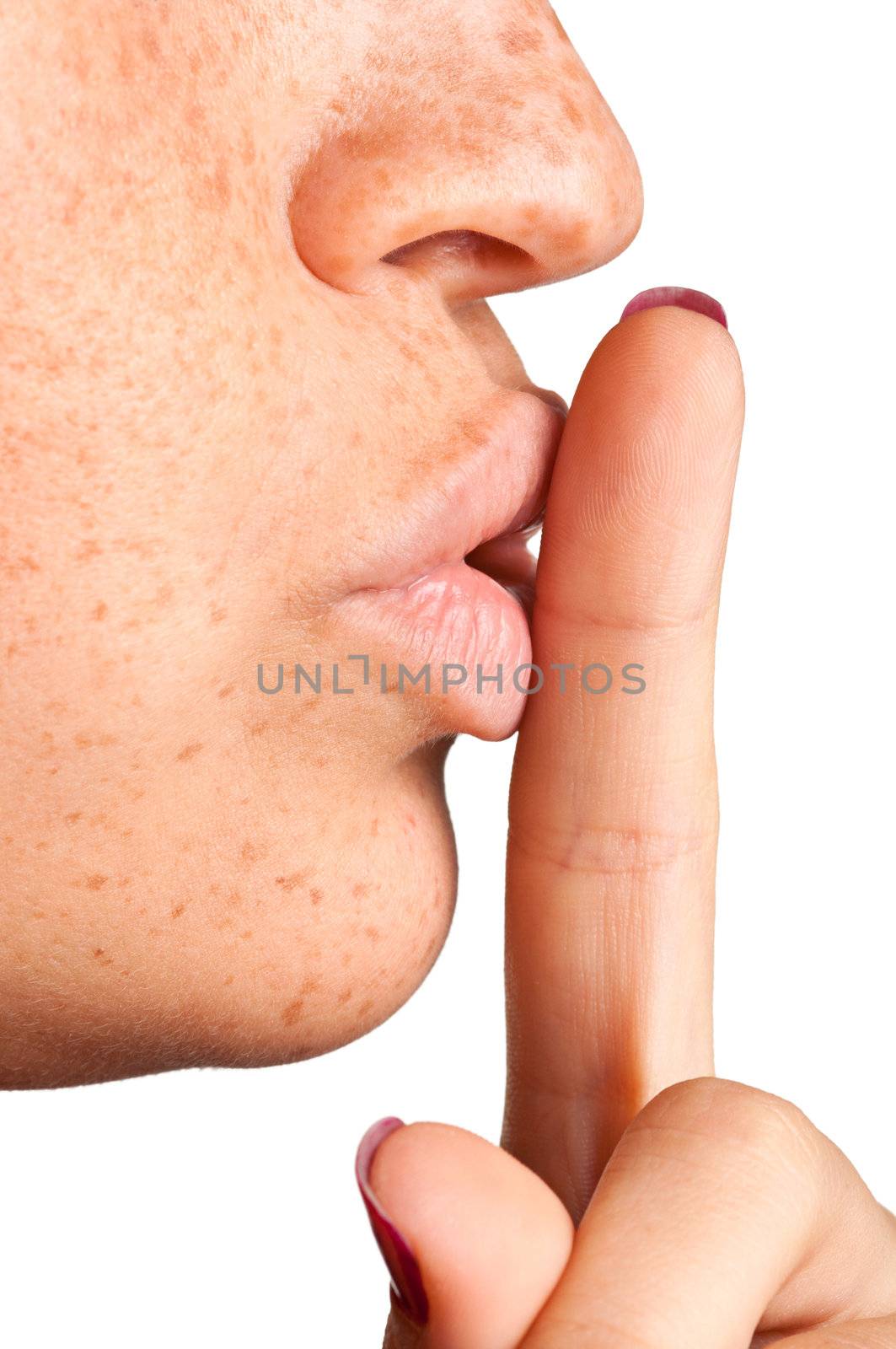 Closeup of a woman with her finger over her mouth