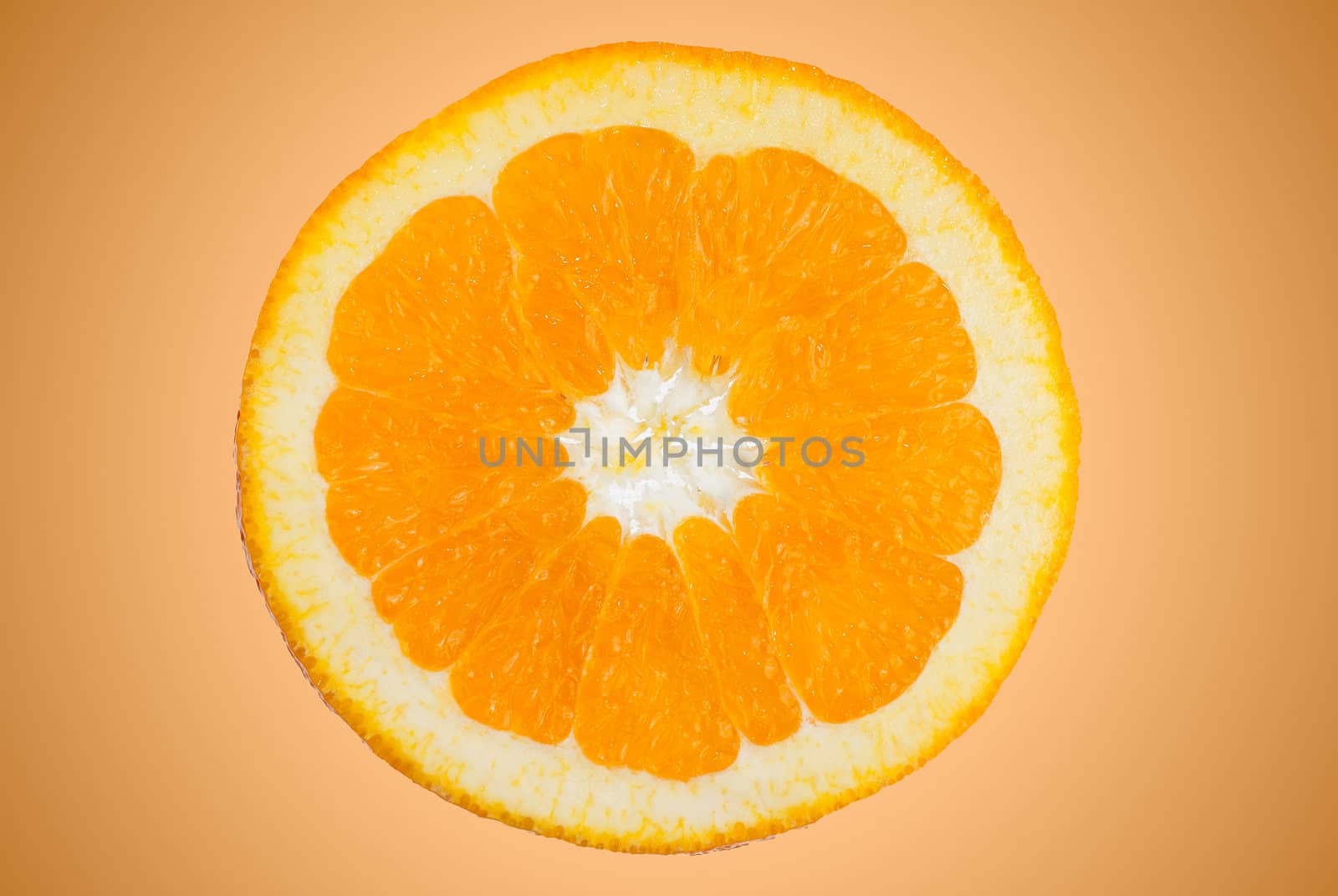 Closeup of orange slice on orange gradient background.