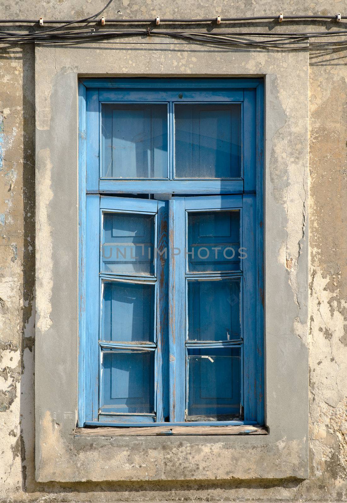 A closed old window with dirty glass.