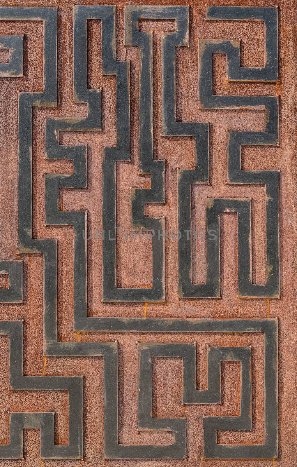 Metal rusty background, with geometrical shapes forming a labyrinth.