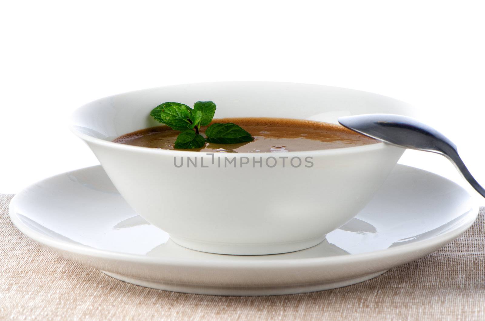 Chocolate mousse on white bowl and plate.