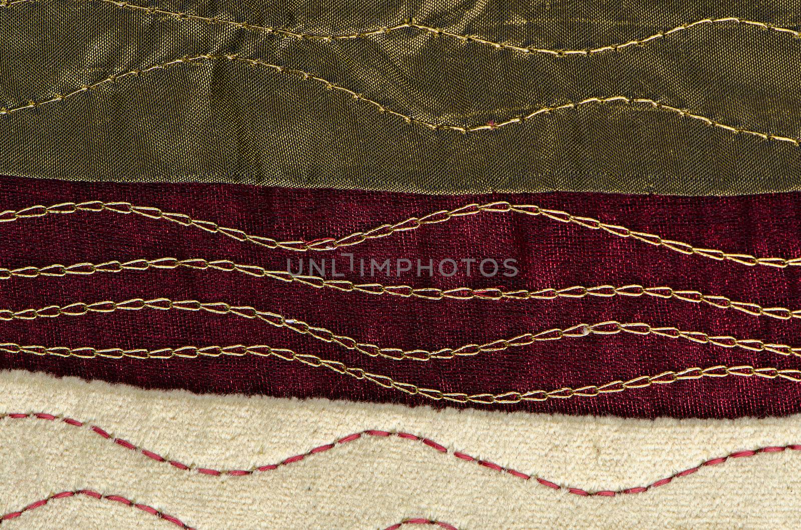 A red cloth texture with strong contrast and lines with golden decorative chains.