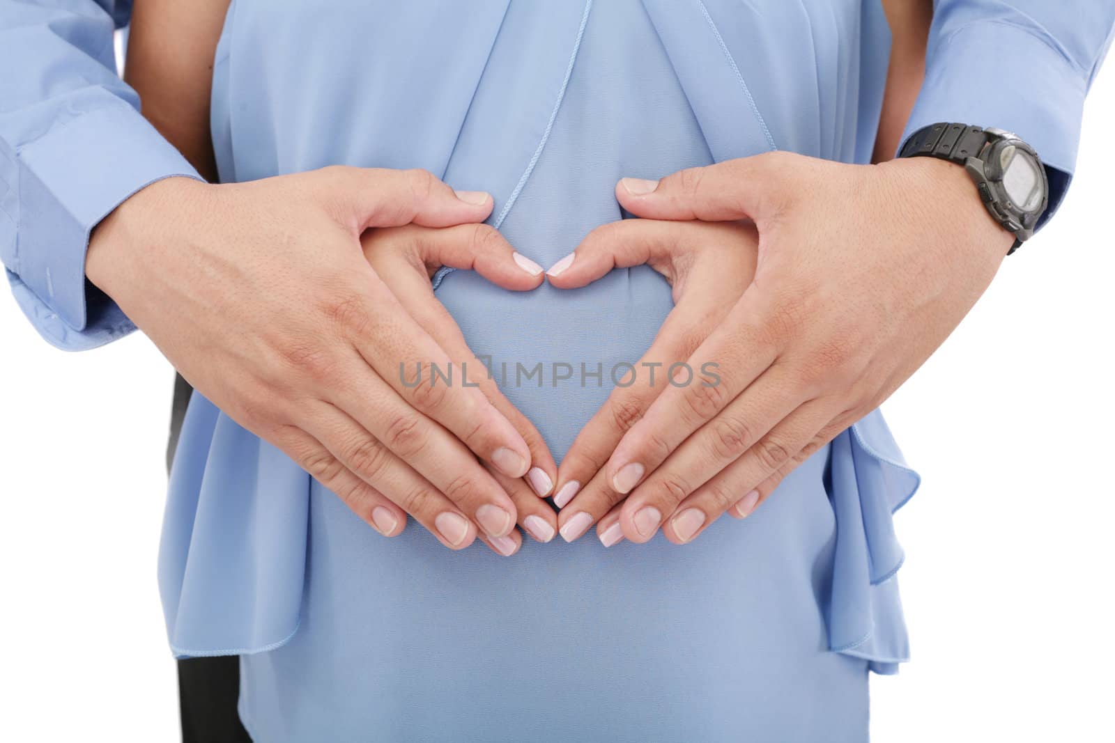 hands of pregnant woman and her husband in heart shape