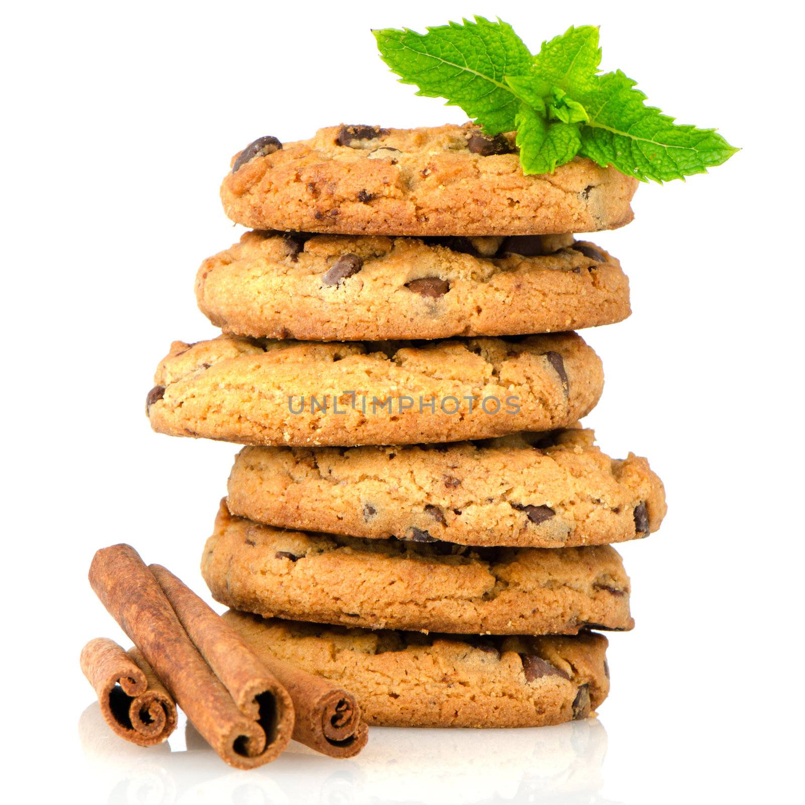 Fresh and tasty oat biscuits with cinnamon sticks on white background.