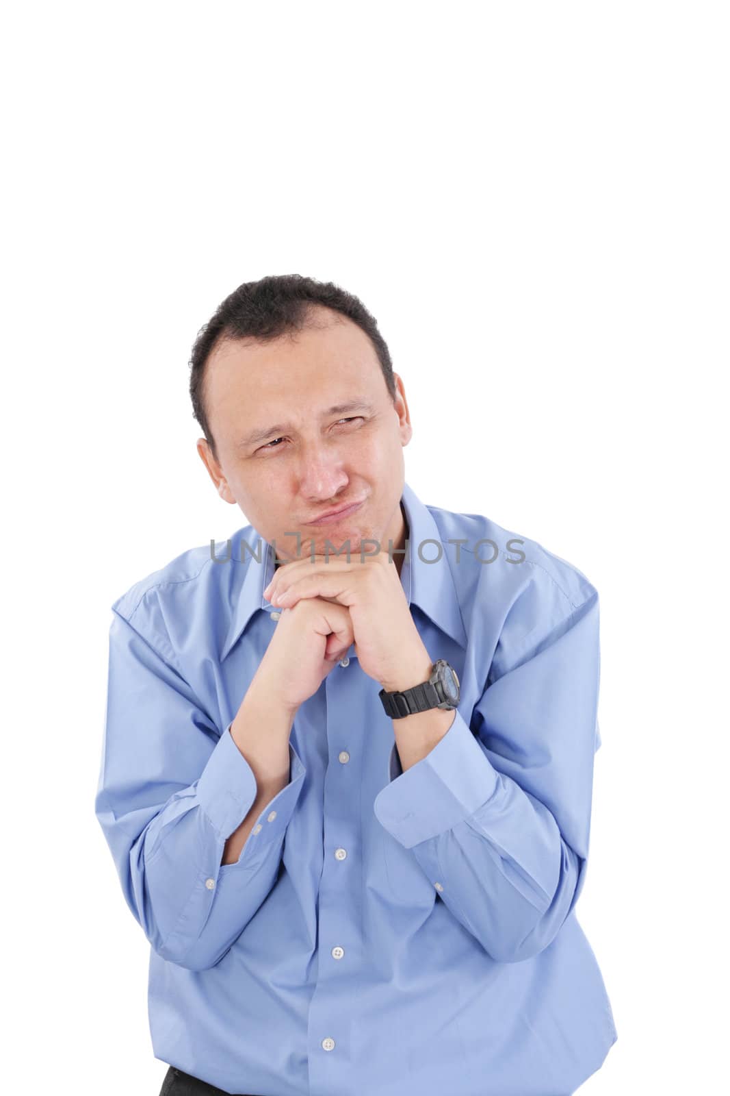 Closeup of frightened young man with funny facial expression against white background