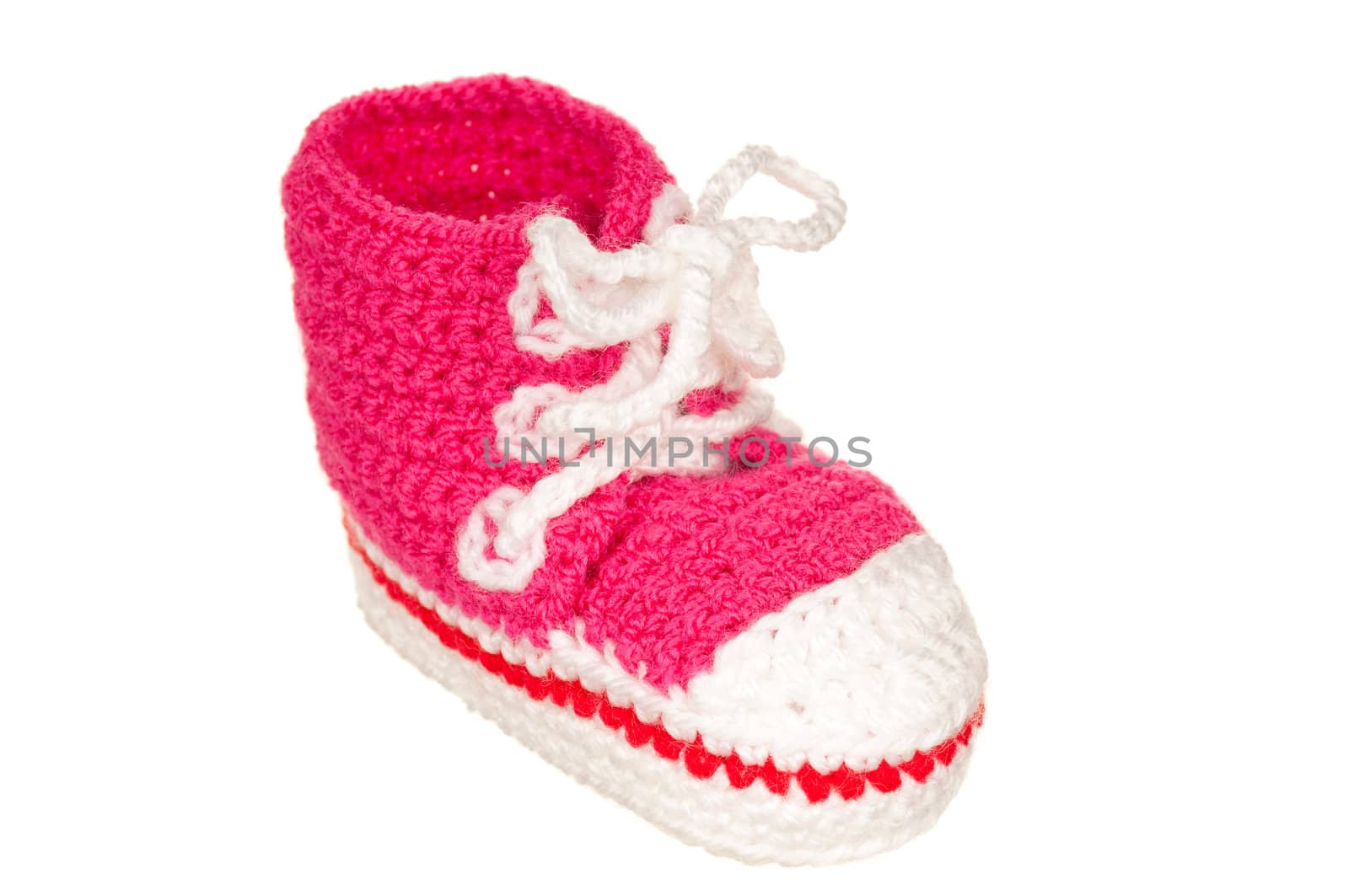 Handmade pink baby booties isolated on white background