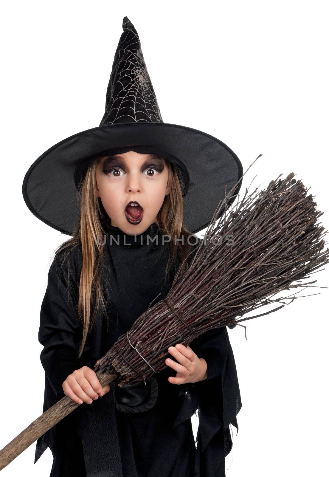 Portrait of little girl in black hat and black clothing with broom on white background