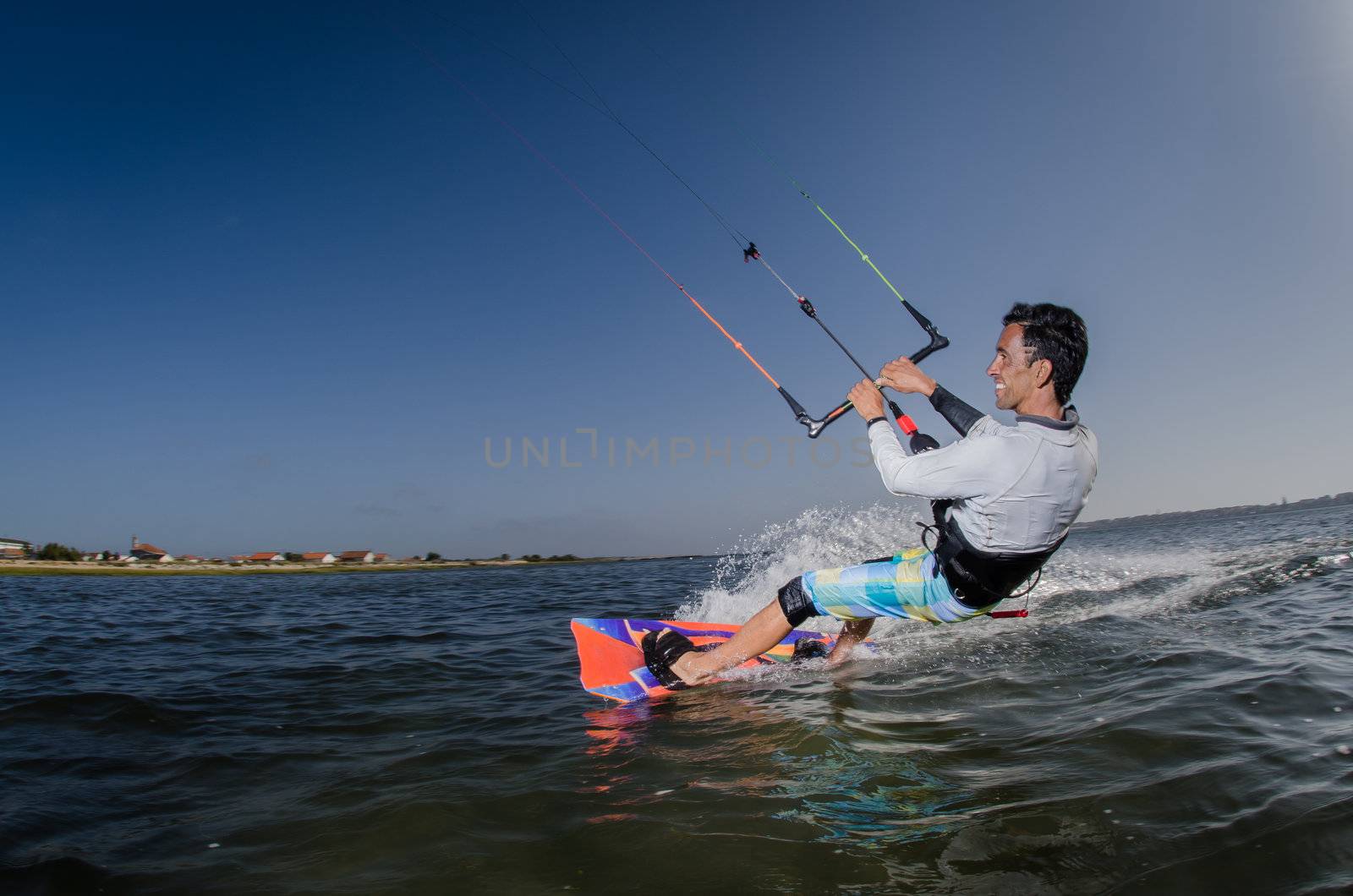 Kiteboarder enjoy surfing on a sunny day.