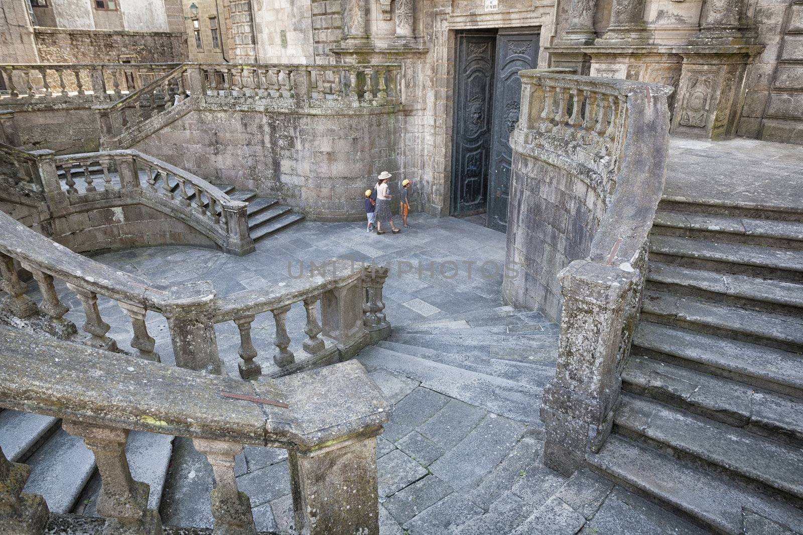 SANTIAGO DE COMPOSTELA, SPAIN - SEPTEMBER 5: Unidentified mother and her two children on their way to visit the San Martin Church in Santiago de Compostela, Spain on september 5, 2012.