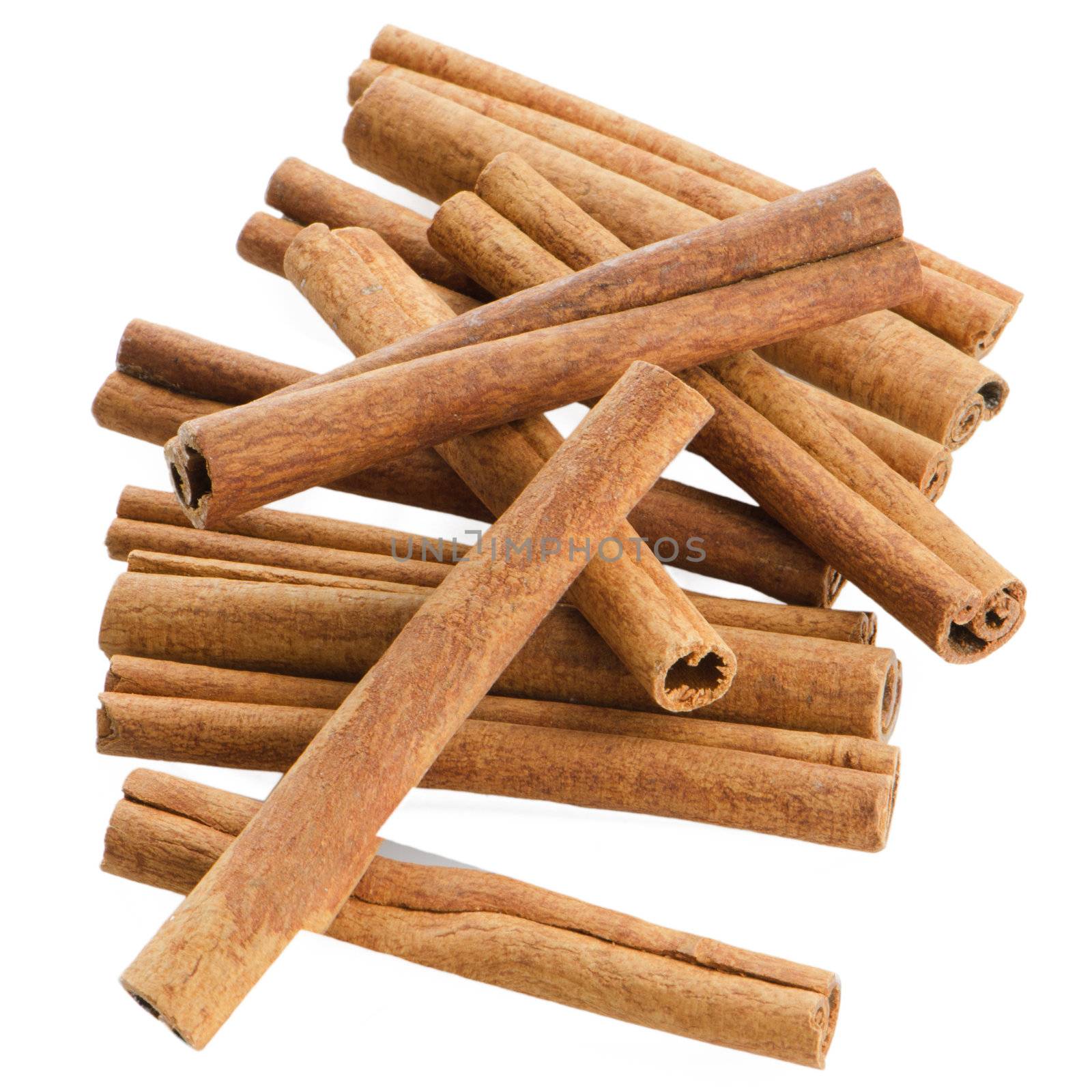 Cinnamon sticks on white reflective background.