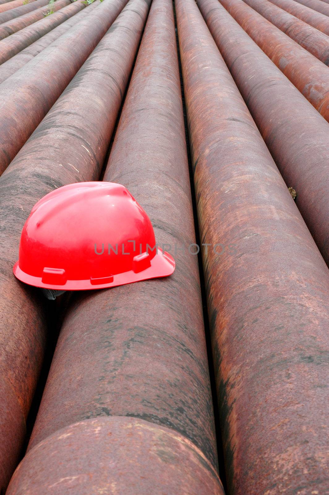 red helmet miner oil on iron pipe by antonihalim