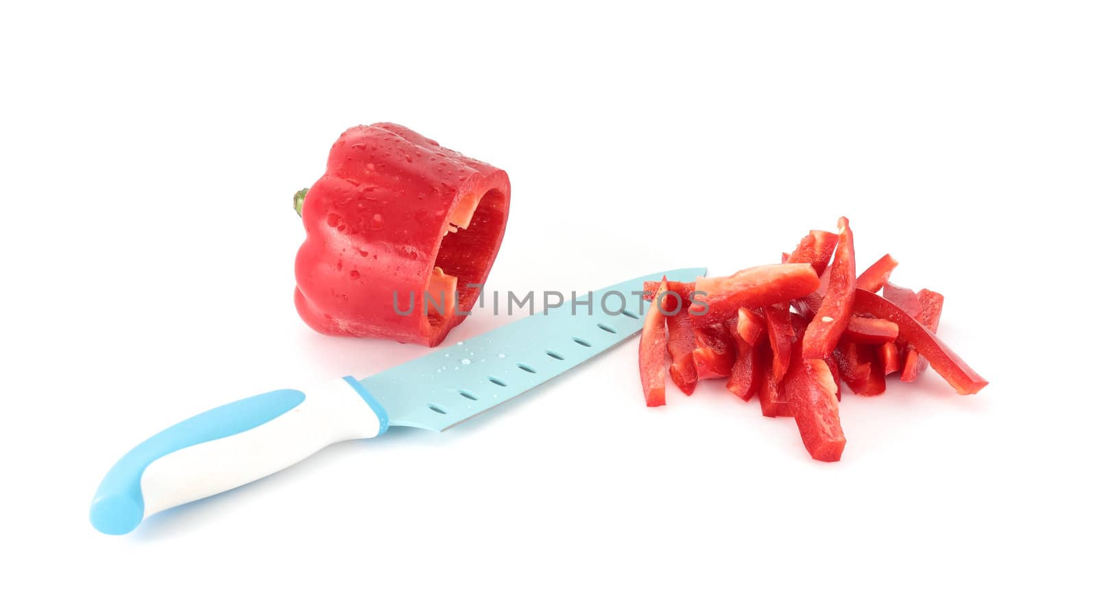 Chopped red pepper with kitchen knife isolated on white