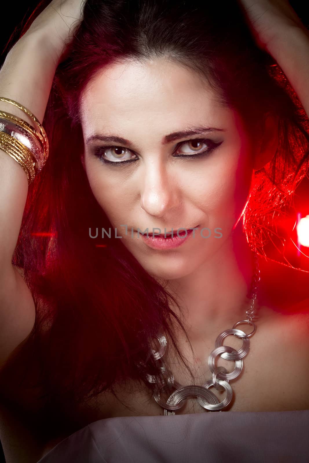 closeup portrait of sexy woman in red party light