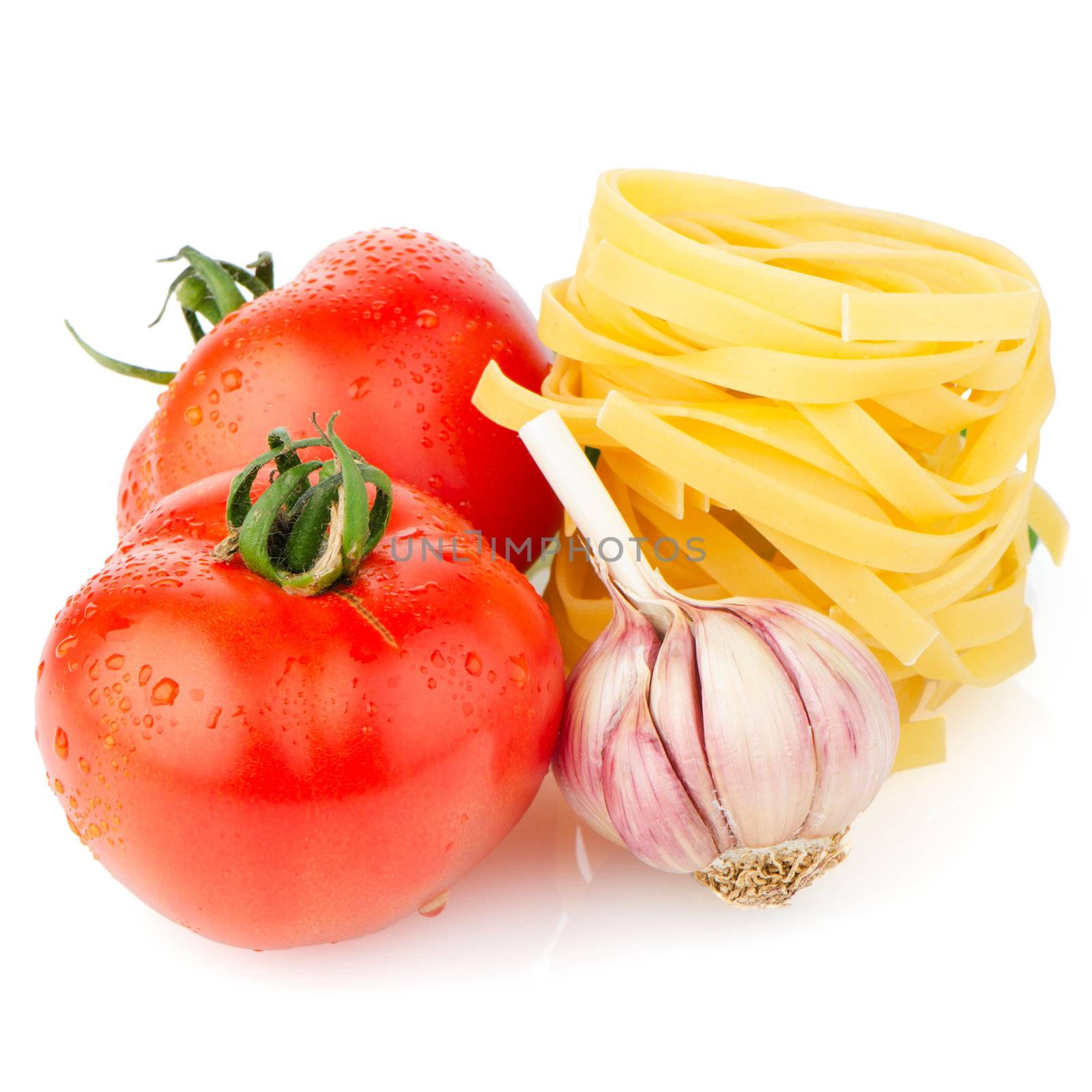 Composition of: tomato, tagliatelli, garlic and  basil Isolated on white background.