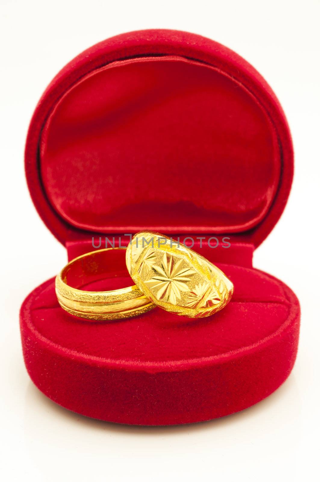 Red velvet box with golden rings